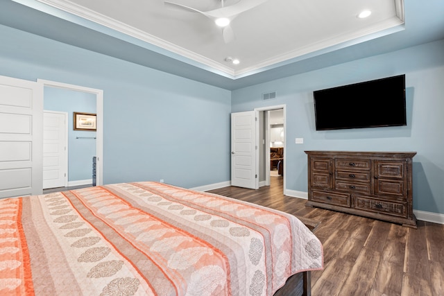 bedroom featuring visible vents, baseboards, a raised ceiling, ornamental molding, and dark wood-style flooring