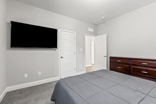 bedroom with carpet, visible vents, and baseboards