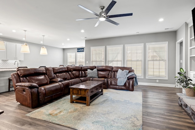 living room with recessed lighting, ceiling fan, baseboards, and wood finished floors