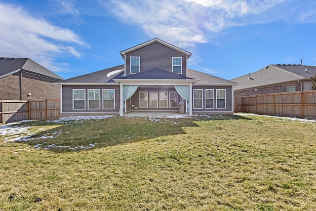 back of house featuring a lawn, a patio area, and a fenced backyard