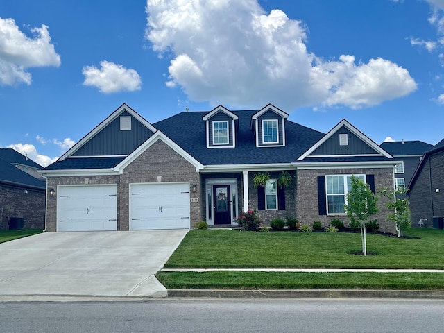 view of front of house with driveway, a front lawn, board and batten siding, and brick siding