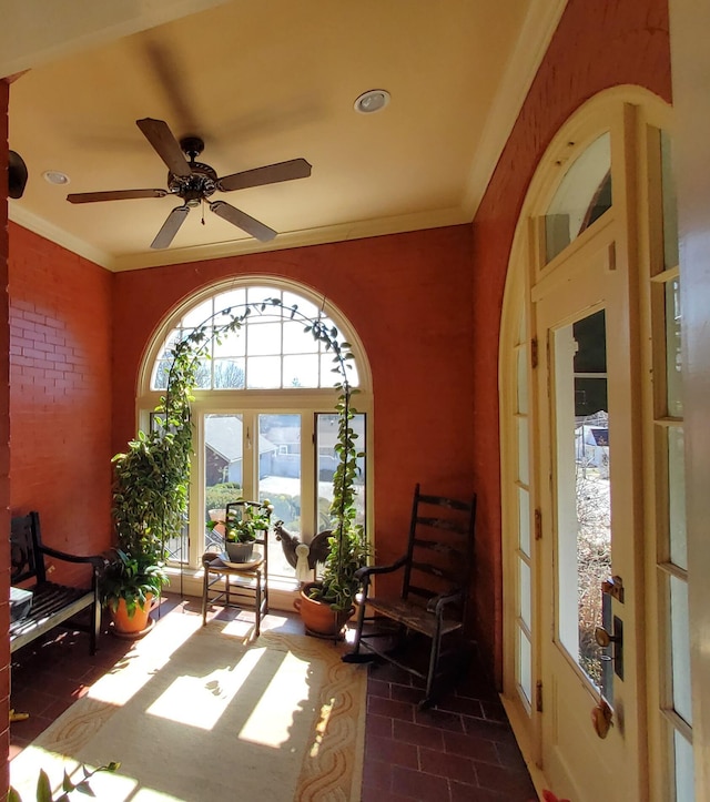 sunroom / solarium with a ceiling fan