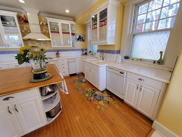 kitchen with a sink, white cabinets, dishwasher, open shelves, and glass insert cabinets