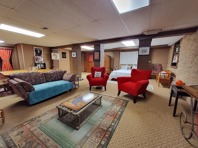 carpeted living area featuring a drop ceiling and visible vents