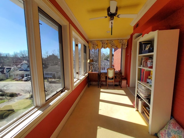 sunroom / solarium featuring visible vents and a ceiling fan