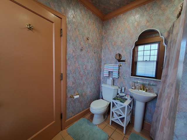 bathroom with a sink, tile patterned flooring, toilet, and baseboards