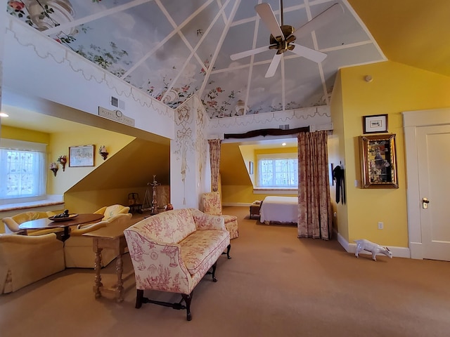 sitting room with ceiling fan, high vaulted ceiling, carpet flooring, and baseboards