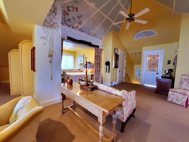 dining area featuring ceiling fan, carpet floors, high vaulted ceiling, and baseboards