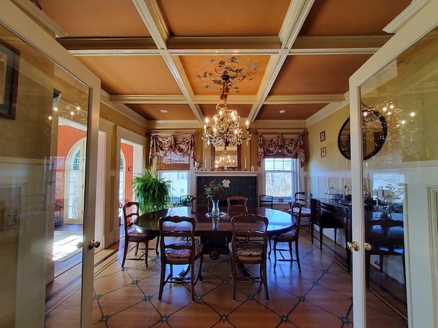 dining room with french doors, beamed ceiling, coffered ceiling, and a notable chandelier