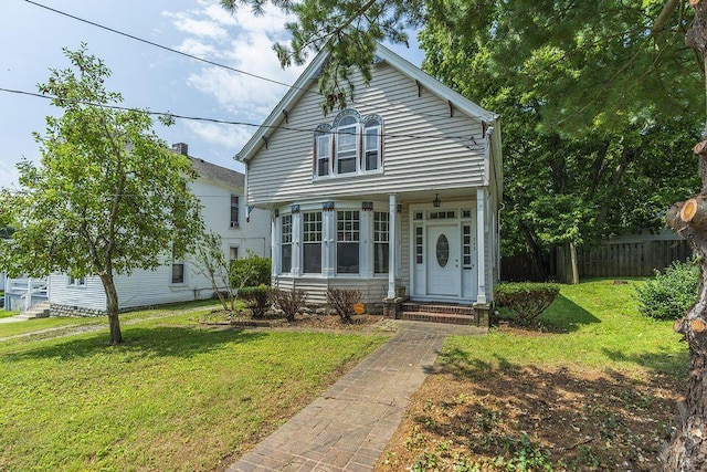 view of front of house with a front yard, fence, and entry steps