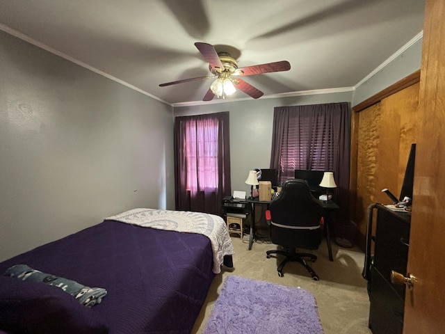 bedroom with light carpet, ceiling fan, a closet, and crown molding