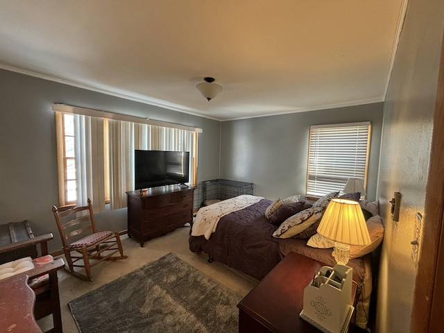 bedroom with ornamental molding and light colored carpet