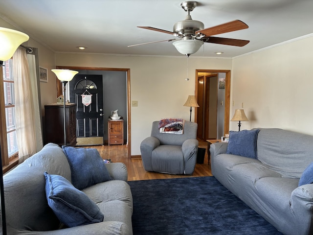 living area with ornamental molding, wood finished floors, a ceiling fan, and recessed lighting