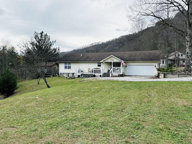 ranch-style house featuring a garage, driveway, and a front lawn