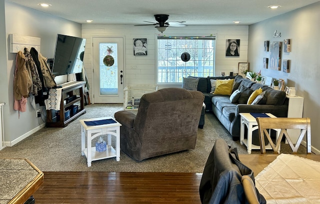 living area featuring recessed lighting, wood finished floors, a ceiling fan, and baseboards