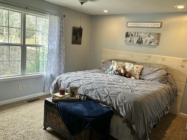 bedroom with baseboards, visible vents, a textured ceiling, carpet floors, and recessed lighting