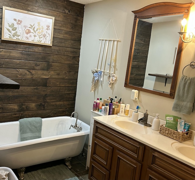 bathroom featuring double vanity, wood walls, a soaking tub, and a sink