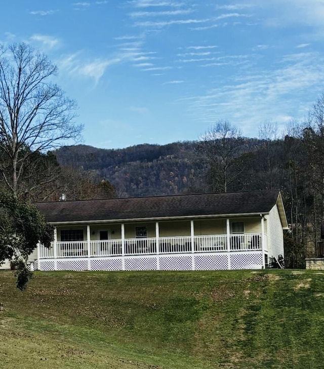 exterior space featuring a lawn and a mountain view