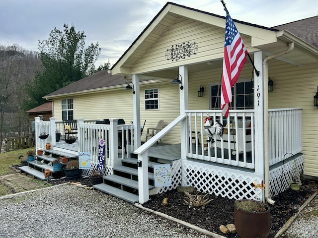 view of front of house with a porch and roof with shingles