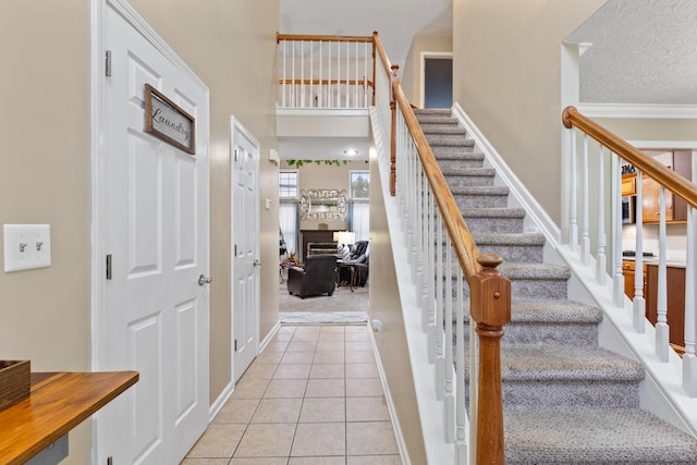 stairs featuring tile patterned flooring and baseboards