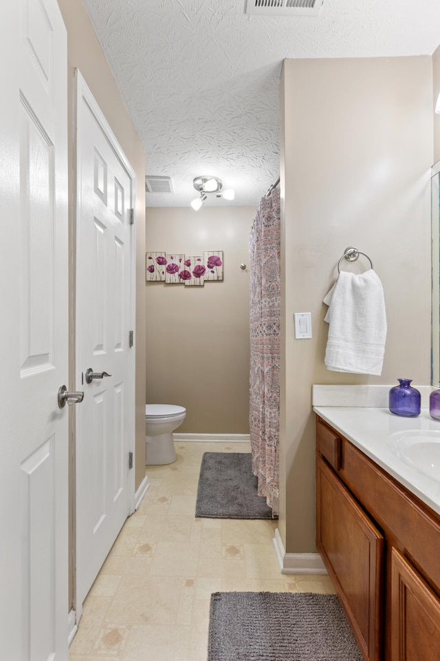 full bath featuring a textured ceiling, toilet, vanity, and visible vents