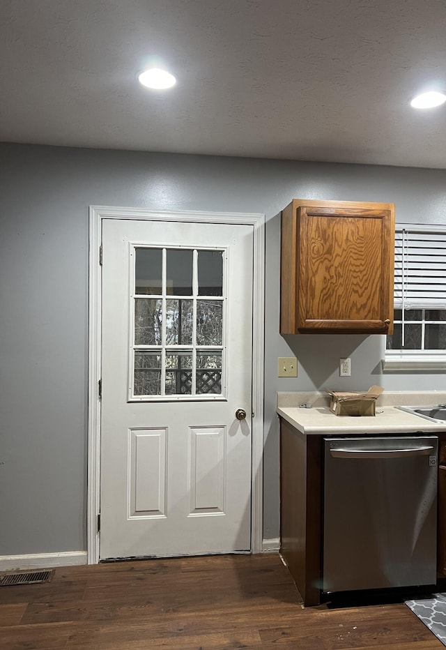 interior space featuring dark wood-style floors, recessed lighting, light countertops, visible vents, and stainless steel dishwasher