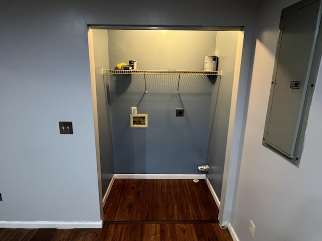 clothes washing area with laundry area, baseboards, dark wood-style flooring, hookup for a washing machine, and electric dryer hookup