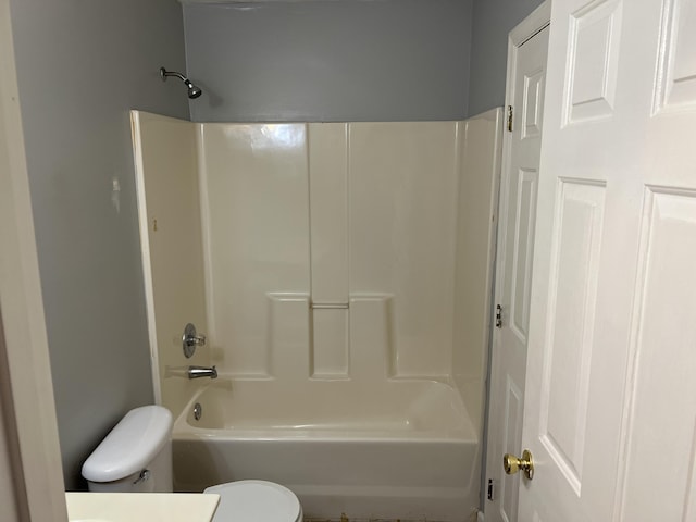 bathroom with washtub / shower combination, vanity, and toilet