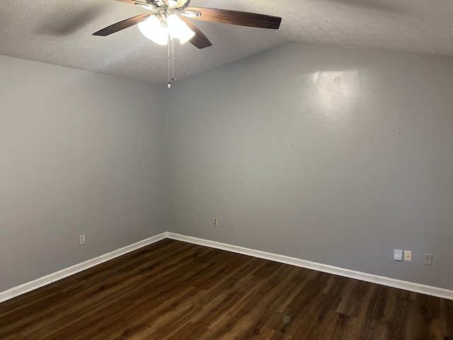 empty room featuring a ceiling fan, dark wood finished floors, a textured ceiling, and baseboards