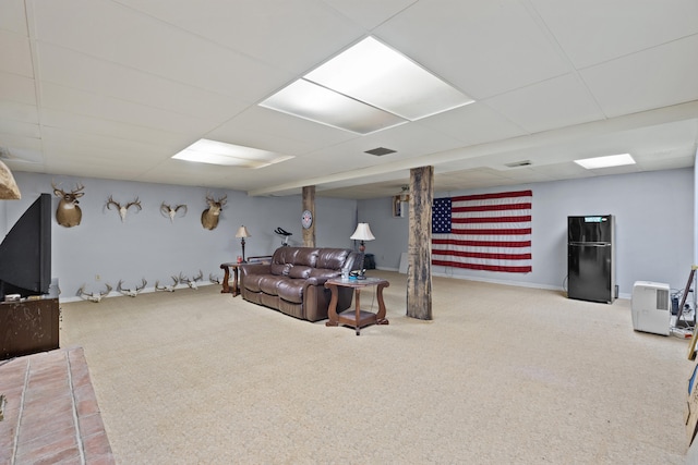 carpeted living room featuring visible vents, a paneled ceiling, and baseboards