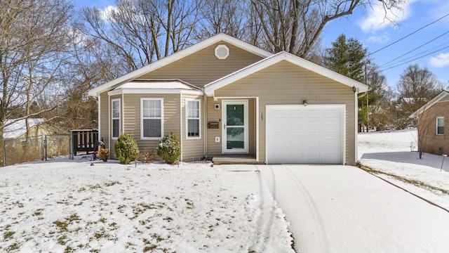 view of front of property with an attached garage and fence