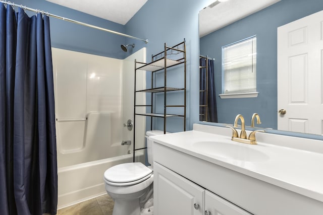 full bath with shower / bath combo, vanity, toilet, and tile patterned floors