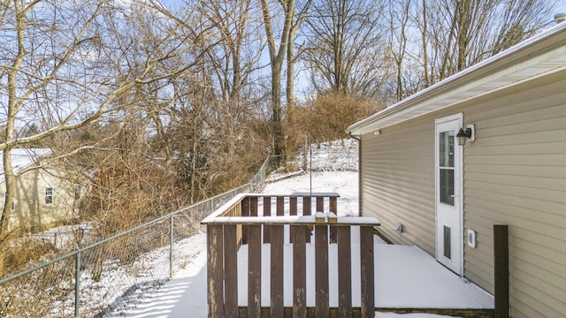 snow covered deck with fence