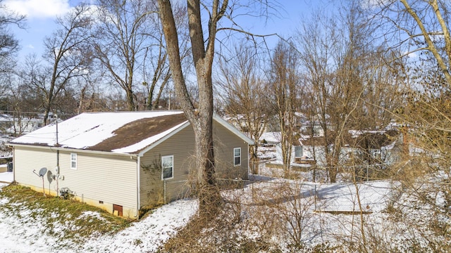 snow covered property featuring crawl space