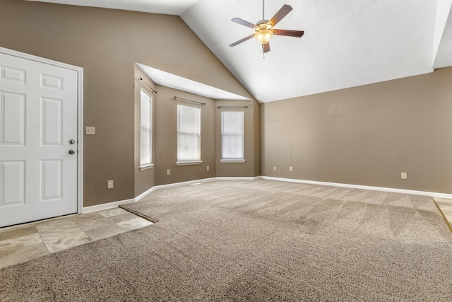 interior space with light carpet, ceiling fan, high vaulted ceiling, and baseboards