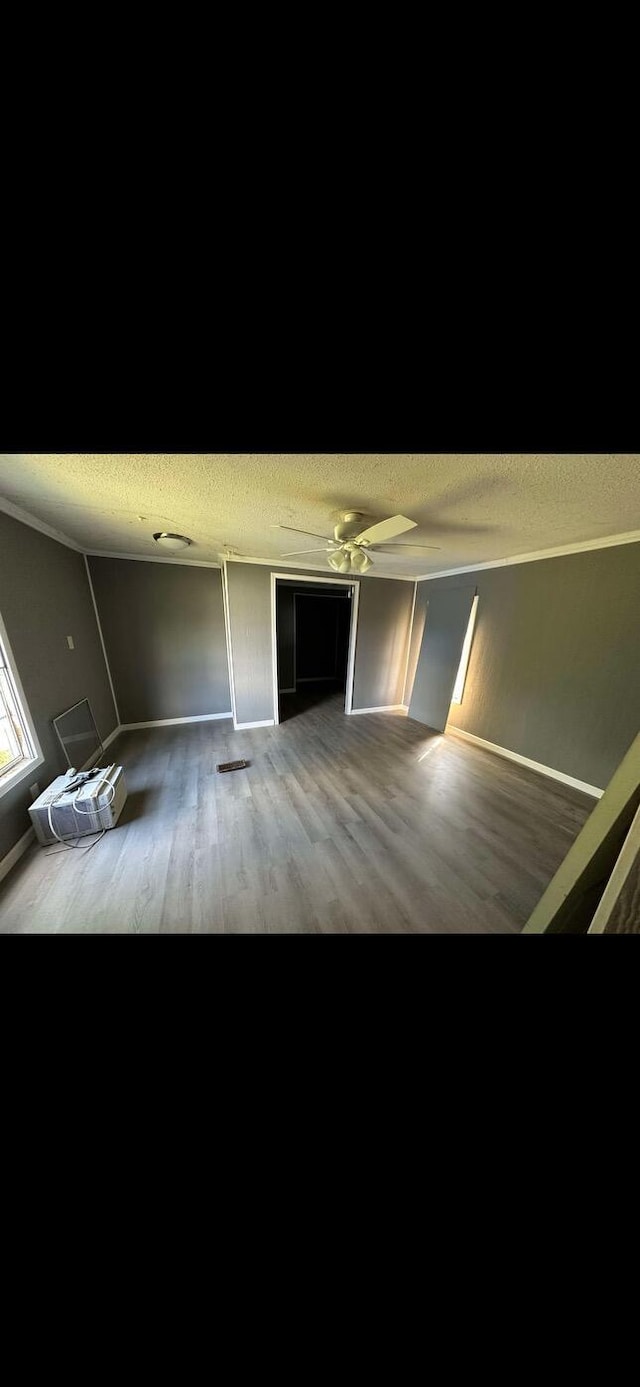 unfurnished bedroom with a textured ceiling and wood finished floors