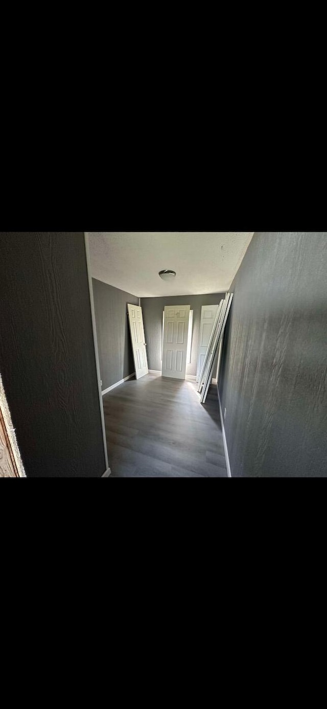 stairway featuring baseboards and wood finished floors