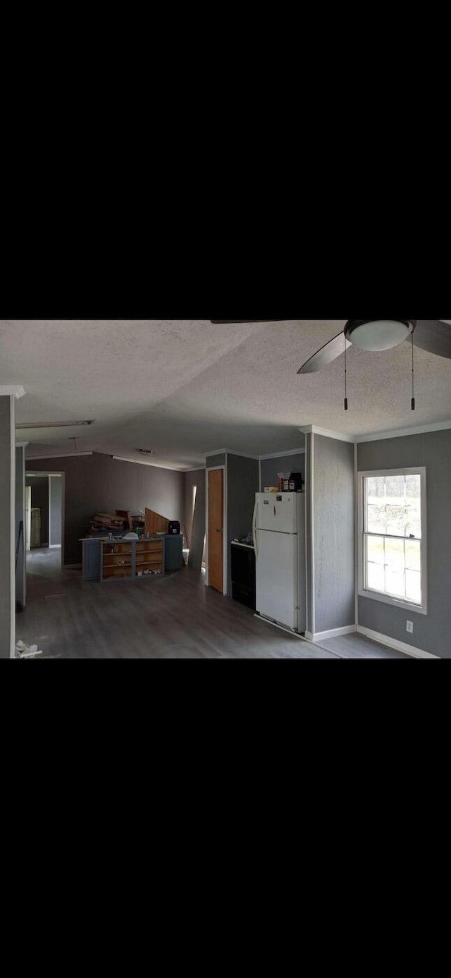 garage featuring freestanding refrigerator and ceiling fan