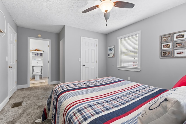 bedroom with carpet, visible vents, a textured ceiling, and baseboards