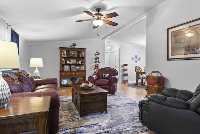 living room featuring lofted ceiling, crown molding, a textured ceiling, and wood finished floors