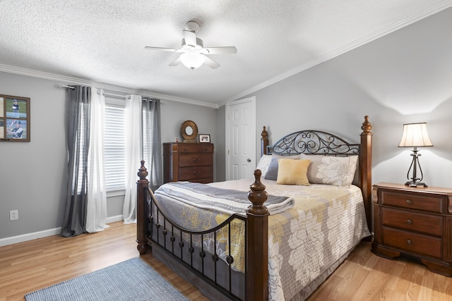 bedroom with ornamental molding, baseboards, light wood-style flooring, and a textured ceiling