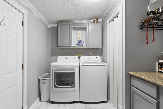 laundry room with washing machine and dryer, marble finish floor, cabinet space, and a textured ceiling