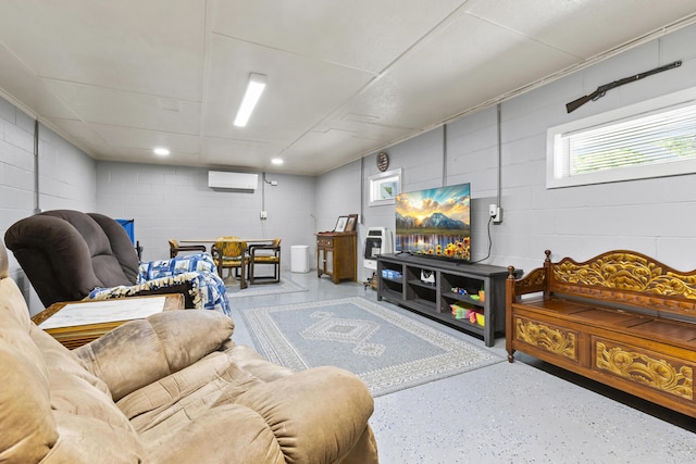 living area with concrete block wall and an AC wall unit