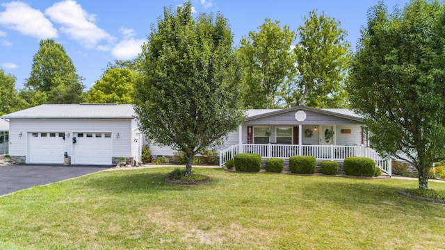 ranch-style home featuring aphalt driveway, covered porch, a front lawn, and a garage