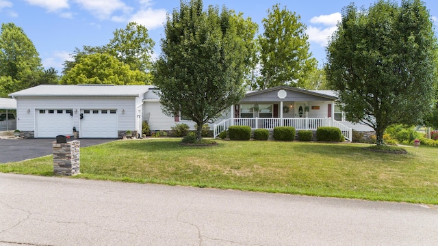 view of front of property with covered porch, a front lawn, a garage, and aphalt driveway