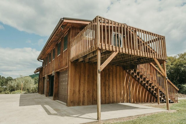 exterior space featuring a garage and stairway