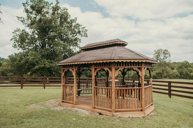 surrounding community featuring a lawn, a gazebo, and fence