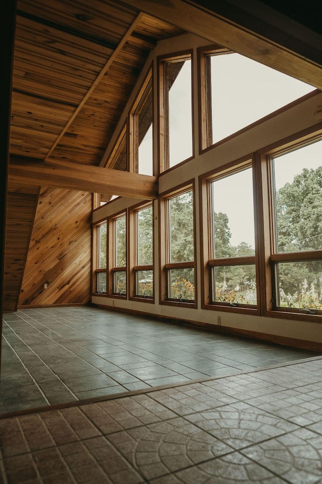 additional living space with wood walls and high vaulted ceiling