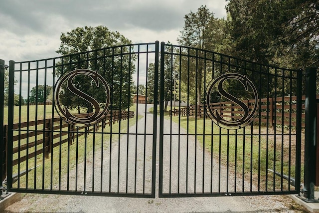 view of gate featuring a yard