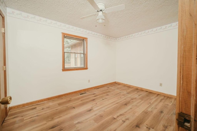 unfurnished room featuring a textured ceiling, ceiling fan, light wood-type flooring, and baseboards